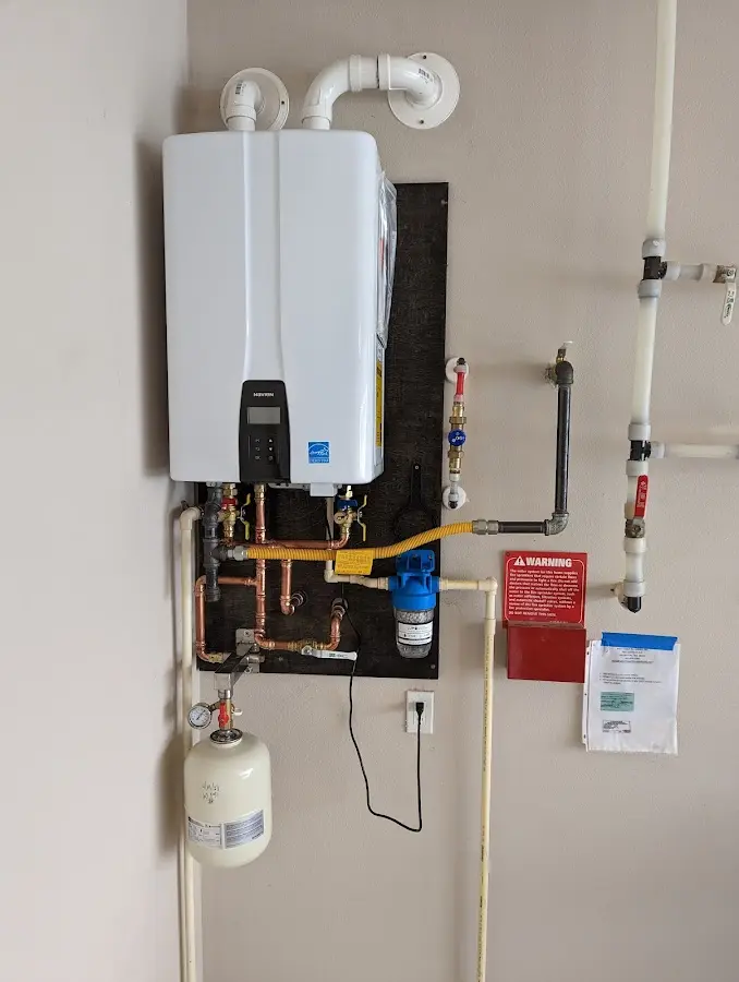 Professional plumber installing copper piping in a Petersburg home